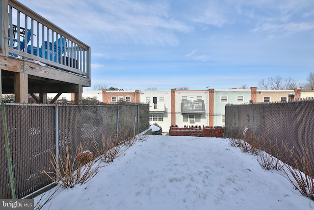 snowy yard with fence