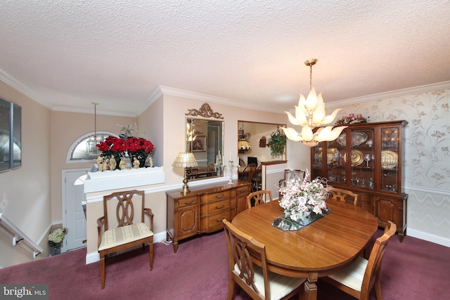 carpeted dining area featuring a chandelier, a textured ceiling, baseboards, ornamental molding, and wallpapered walls