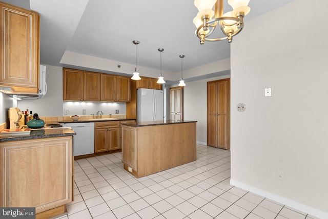 kitchen with white refrigerator, dishwasher, a center island, and pendant lighting