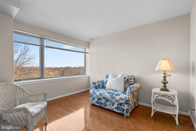 sitting room with hardwood / wood-style flooring