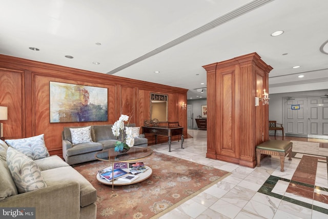 living room featuring crown molding and wood walls