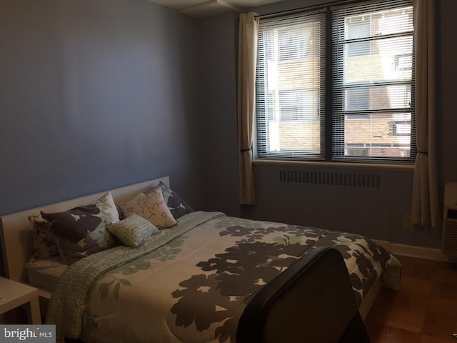 bedroom featuring parquet flooring