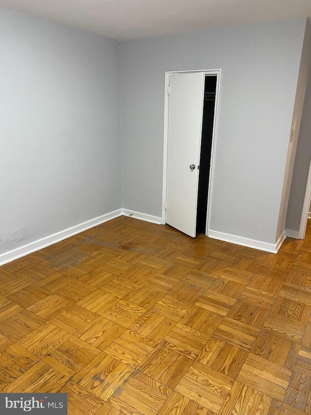 unfurnished room with light parquet flooring