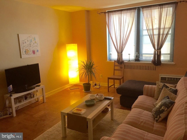 living room featuring parquet flooring and an AC wall unit