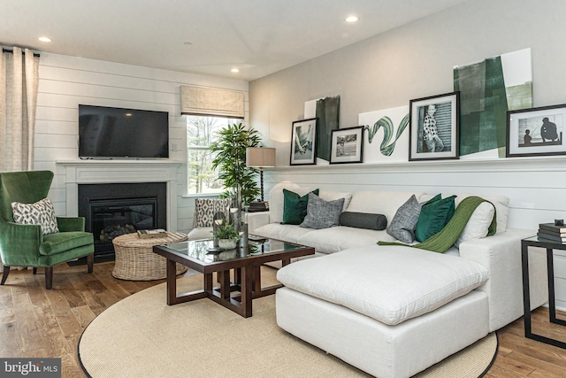 living room featuring wooden walls and hardwood / wood-style floors