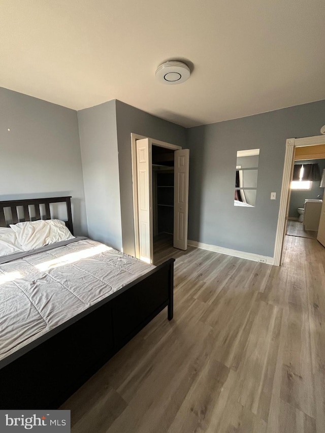 bedroom with hardwood / wood-style flooring