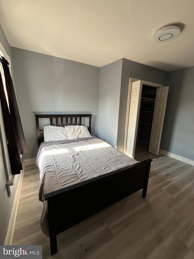 bedroom with wood-type flooring