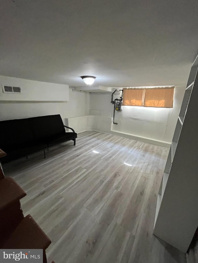 basement with hardwood / wood-style flooring