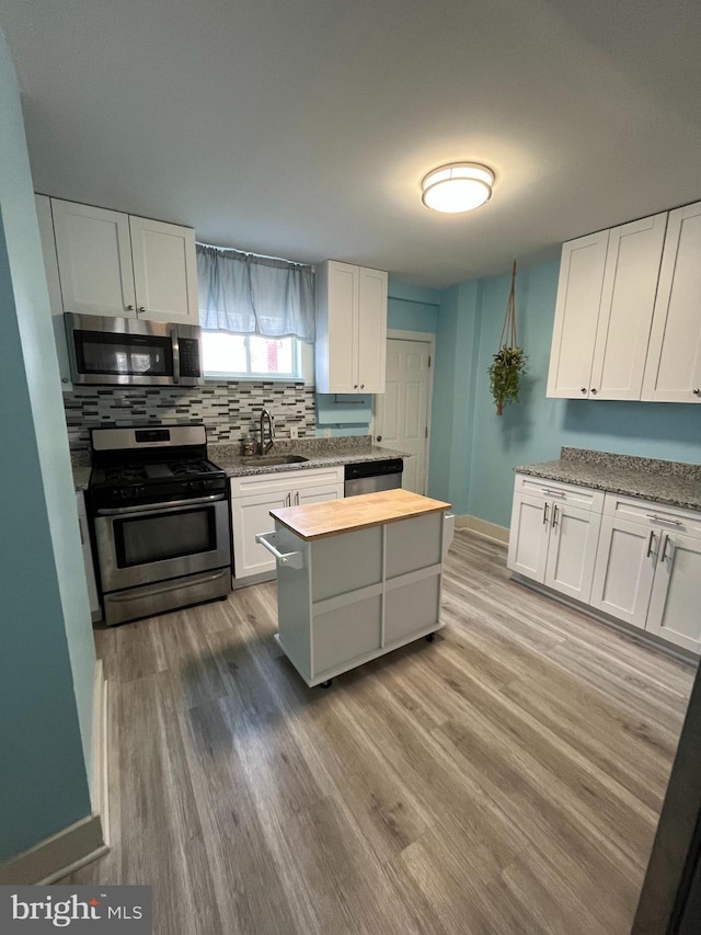 kitchen featuring white cabinetry and appliances with stainless steel finishes