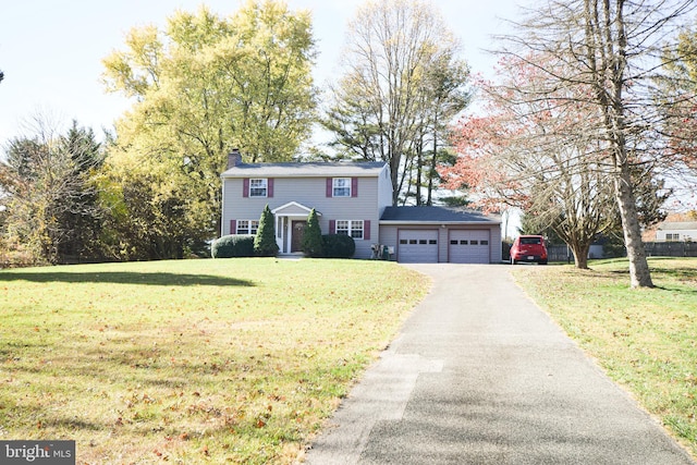 view of front of house with a garage and a front yard