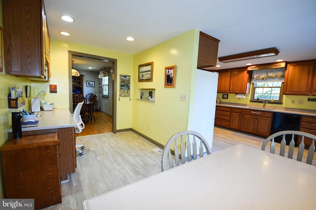 kitchen featuring sink, dishwasher, and light hardwood / wood-style floors