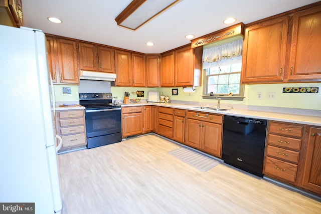 kitchen featuring black dishwasher, white fridge, sink, range with electric stovetop, and light hardwood / wood-style flooring