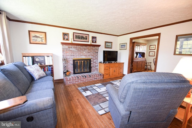 living room featuring a brick fireplace, a textured ceiling, and dark hardwood / wood-style floors