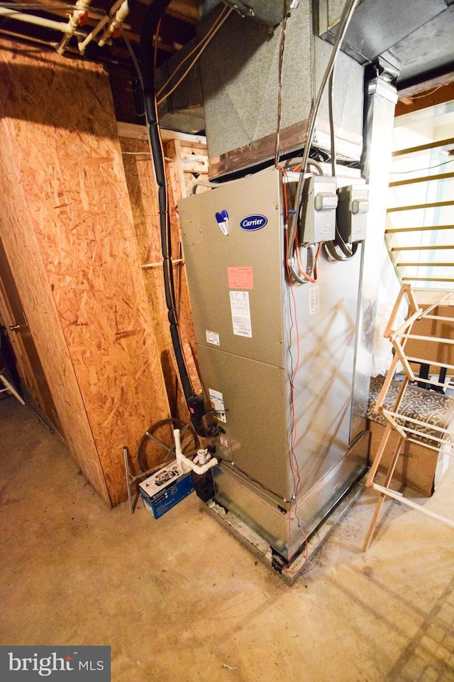 utility room featuring heating unit