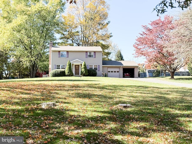 colonial home with a garage and a front yard