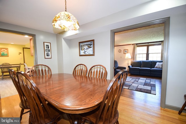 dining space with light wood-type flooring