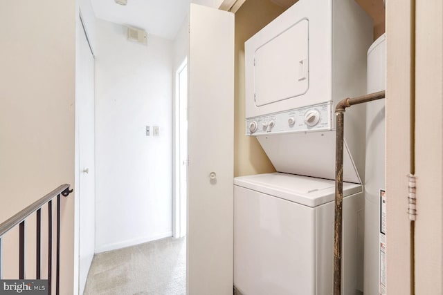 laundry room with stacked washer / drying machine and light carpet