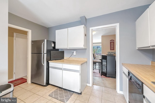 kitchen with white cabinets, stainless steel refrigerator, black dishwasher, and light tile patterned floors