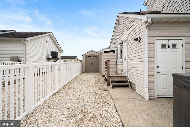 view of side of property with a storage unit