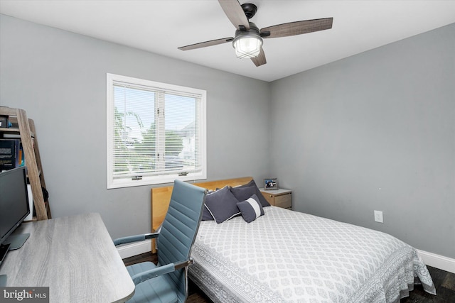 bedroom with ceiling fan and dark wood-type flooring