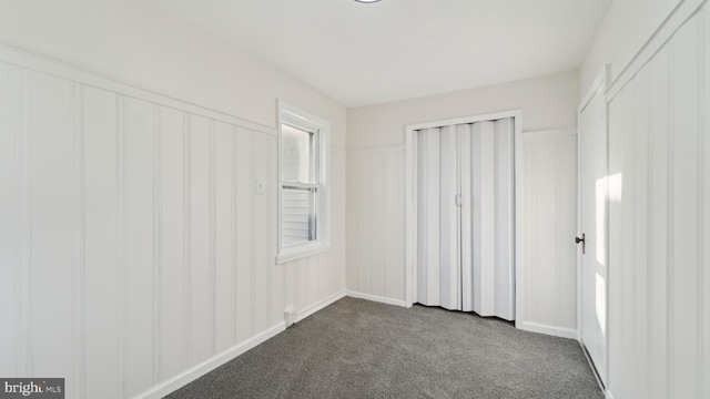 unfurnished bedroom featuring carpet and a closet