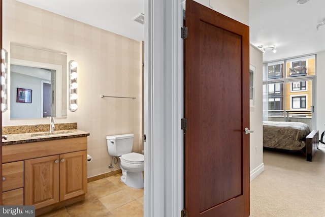 bathroom with tile patterned floors, vanity, and toilet