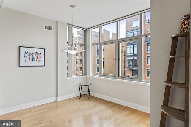 empty room with hardwood / wood-style flooring