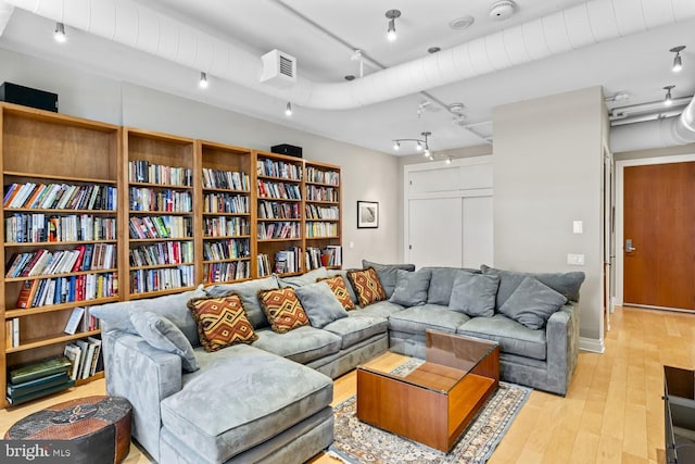 living room featuring track lighting and light hardwood / wood-style floors