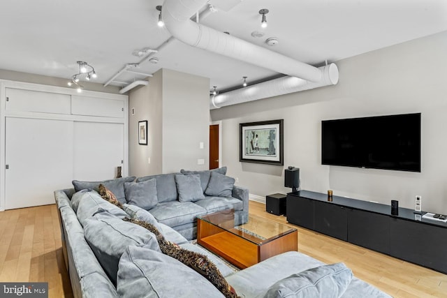 living room featuring rail lighting and light wood-type flooring