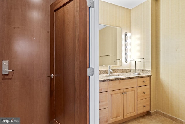 bathroom with tile patterned floors and vanity