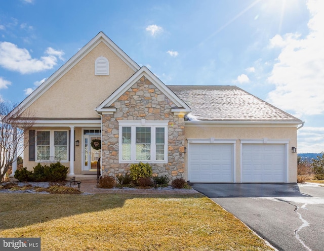 view of front of property with a garage and a front lawn