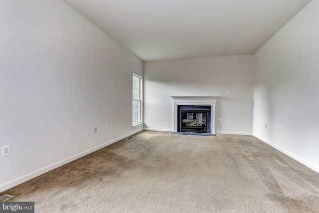 unfurnished living room featuring light carpet