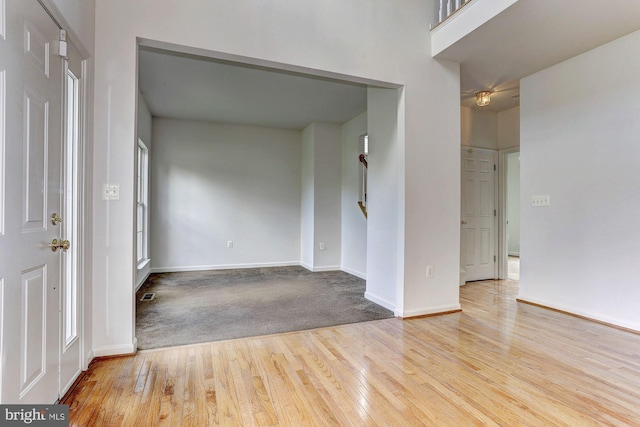 empty room with light hardwood / wood-style flooring