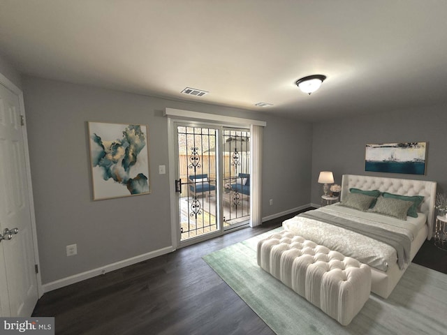 bedroom featuring dark wood-type flooring and access to exterior