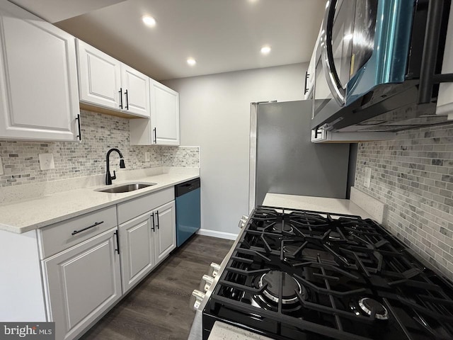 kitchen with sink, white cabinetry, light stone countertops, and appliances with stainless steel finishes