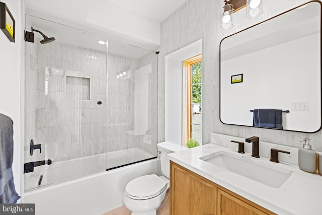 full bathroom with shower / bath combination with glass door, vanity, and toilet