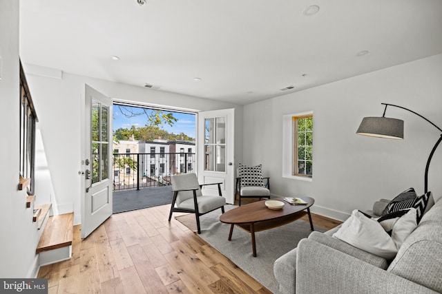 living room with a wealth of natural light and light hardwood / wood-style floors