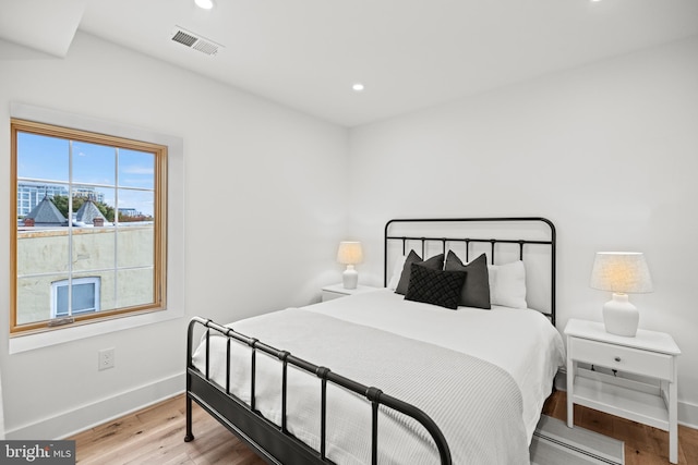 bedroom with hardwood / wood-style floors