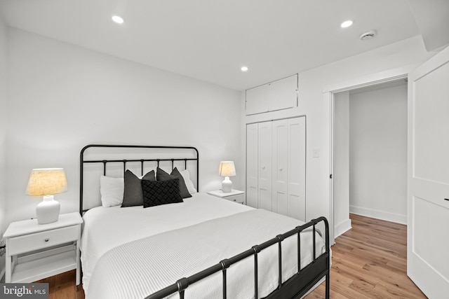 bedroom featuring light wood-type flooring and a closet