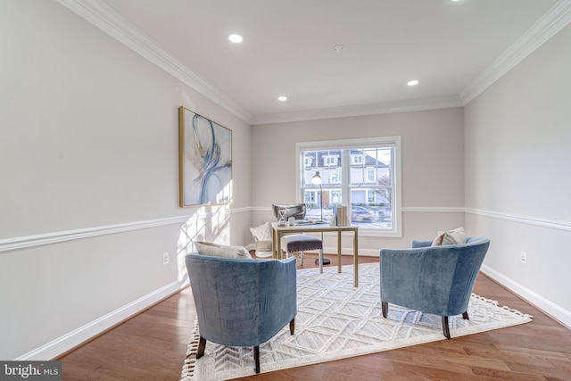 sitting room with hardwood / wood-style floors and ornamental molding