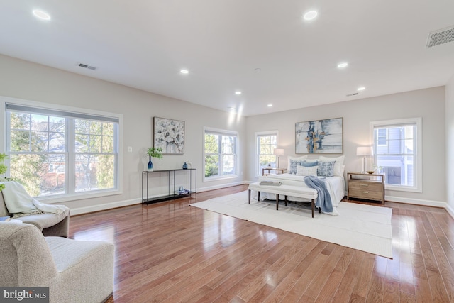 bedroom featuring multiple windows and light wood-type flooring