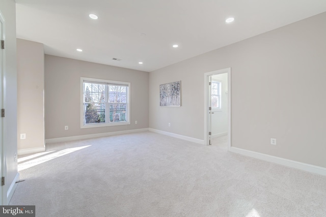 carpeted spare room featuring a healthy amount of sunlight