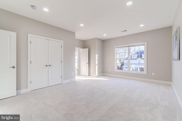 unfurnished bedroom with light colored carpet