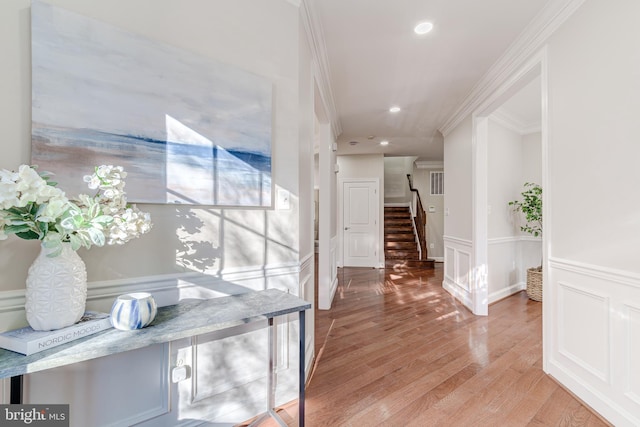 corridor featuring crown molding and light wood-type flooring