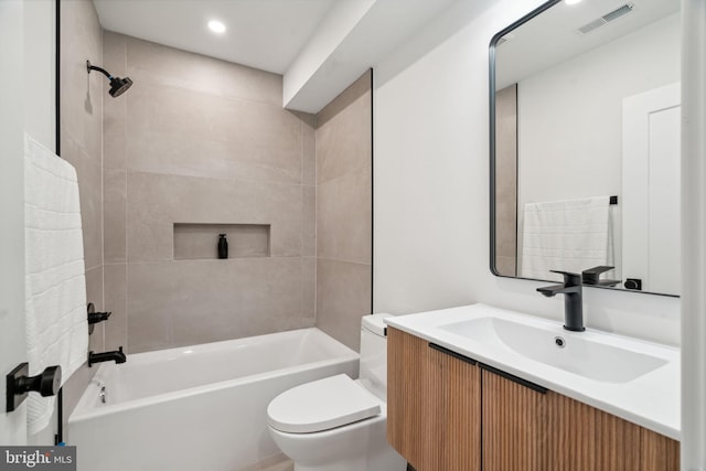 full bathroom with vanity, toilet, and tiled shower / bath combo