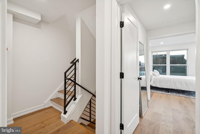 stairway featuring wood-type flooring