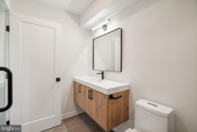 bathroom featuring toilet, tile patterned flooring, and vanity