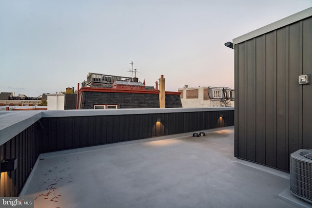 patio terrace at dusk with a balcony and cooling unit