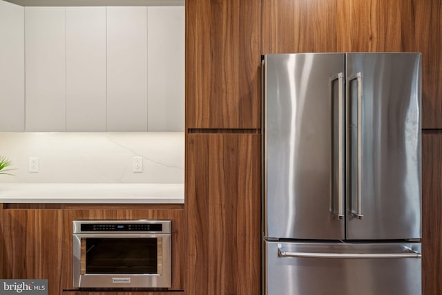 kitchen featuring white cabinets and appliances with stainless steel finishes