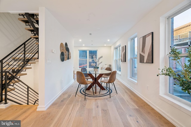 dining area with plenty of natural light and light hardwood / wood-style flooring